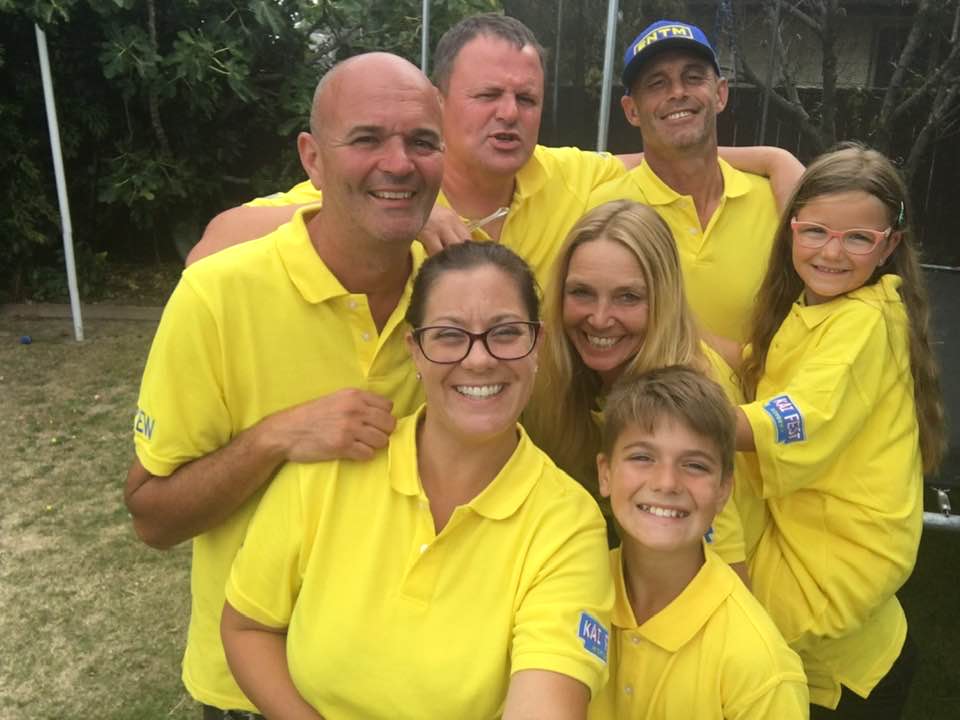 The volunteer crew in yellow Kai Fest shirts, smiling together
